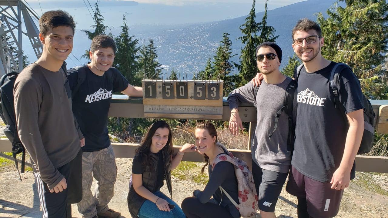 André hiking with friends on a mountain lookout in Canada