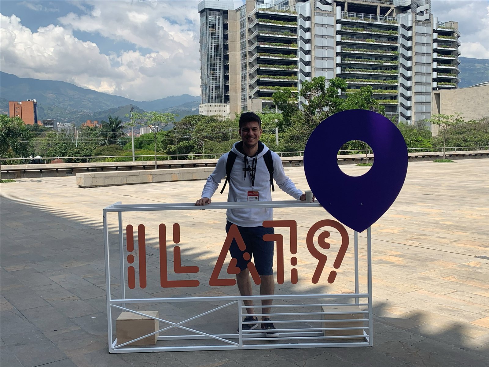 André smiling behind the ILA sign at the Interaction Latin America conference in Medellín